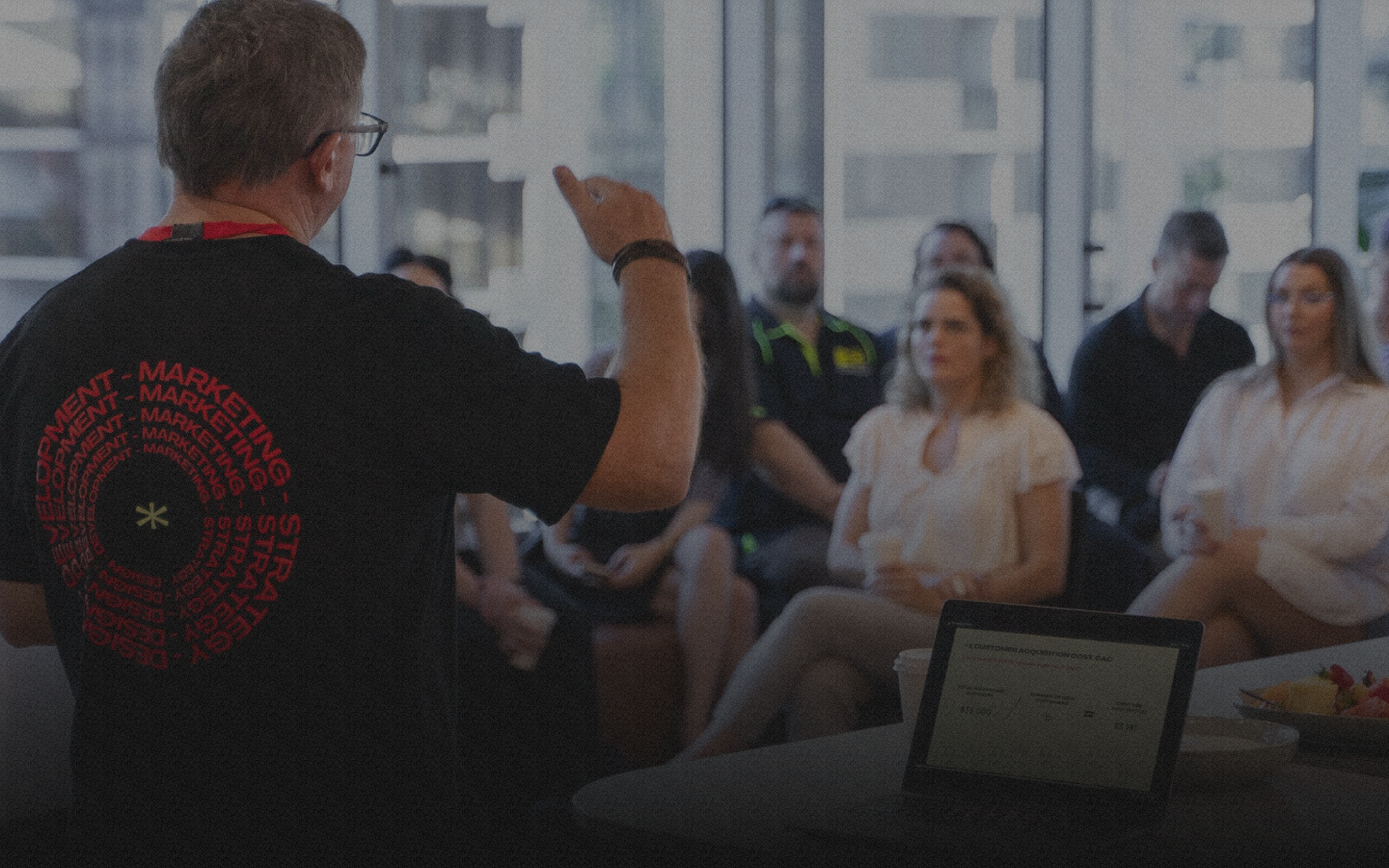 Man presenting marketing strategy to group.