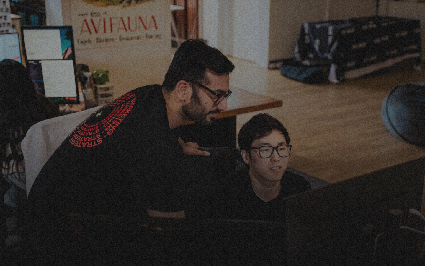 Two men looking at a computer screen.