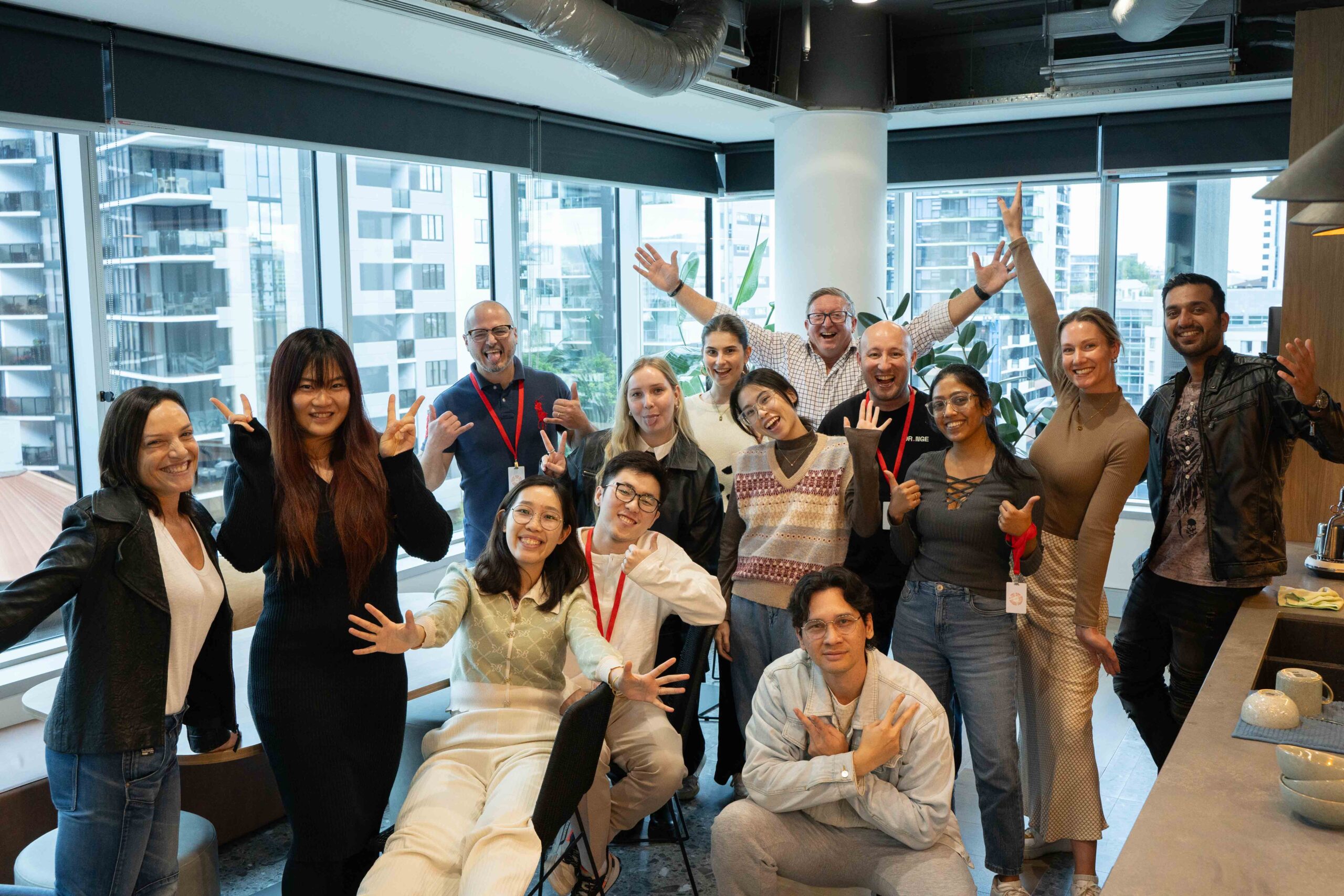 Group of people smiling in an office.